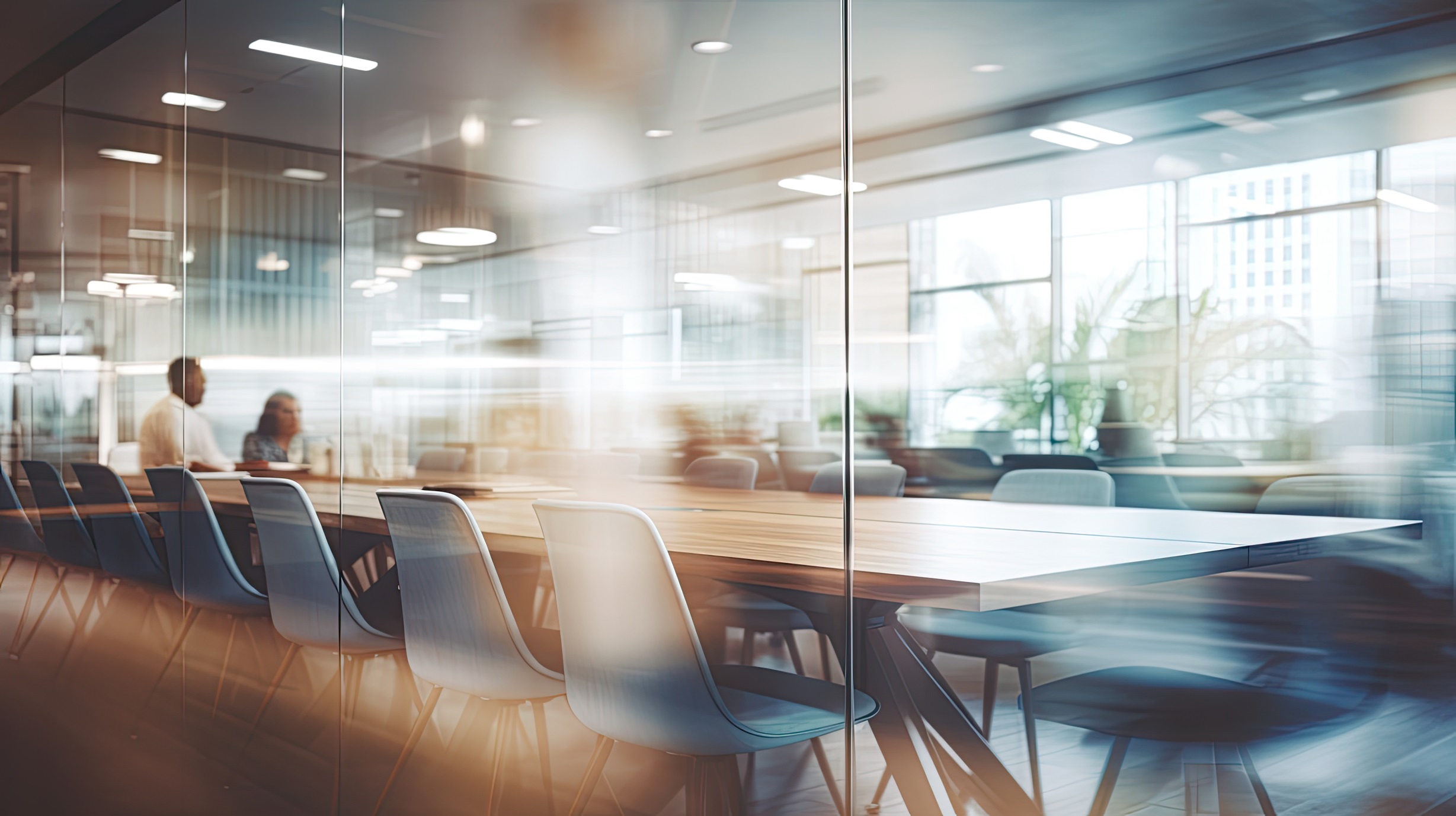 Modern meeting room with glass walls and wooden conference table
